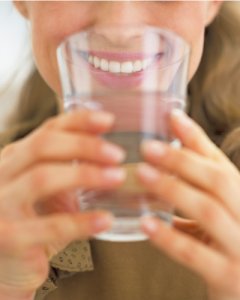 woman drinking water for oral health